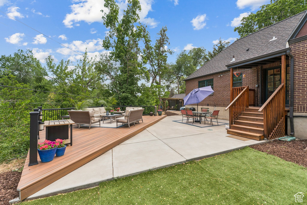 View of patio featuring an outdoor living space and a wooden deck