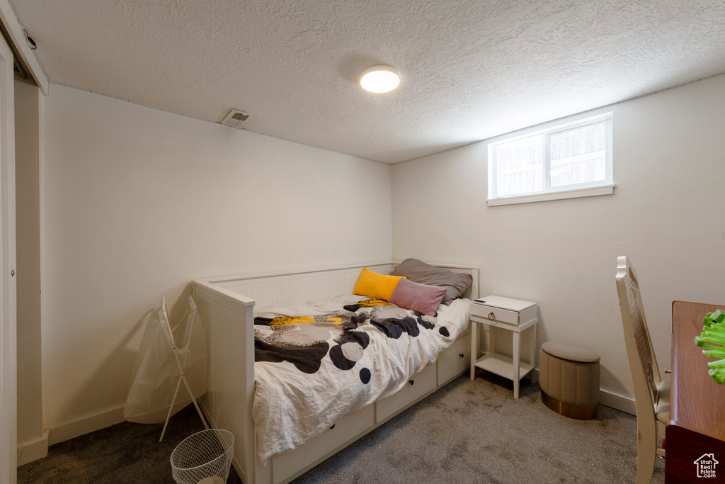 Carpeted bedroom featuring a textured ceiling