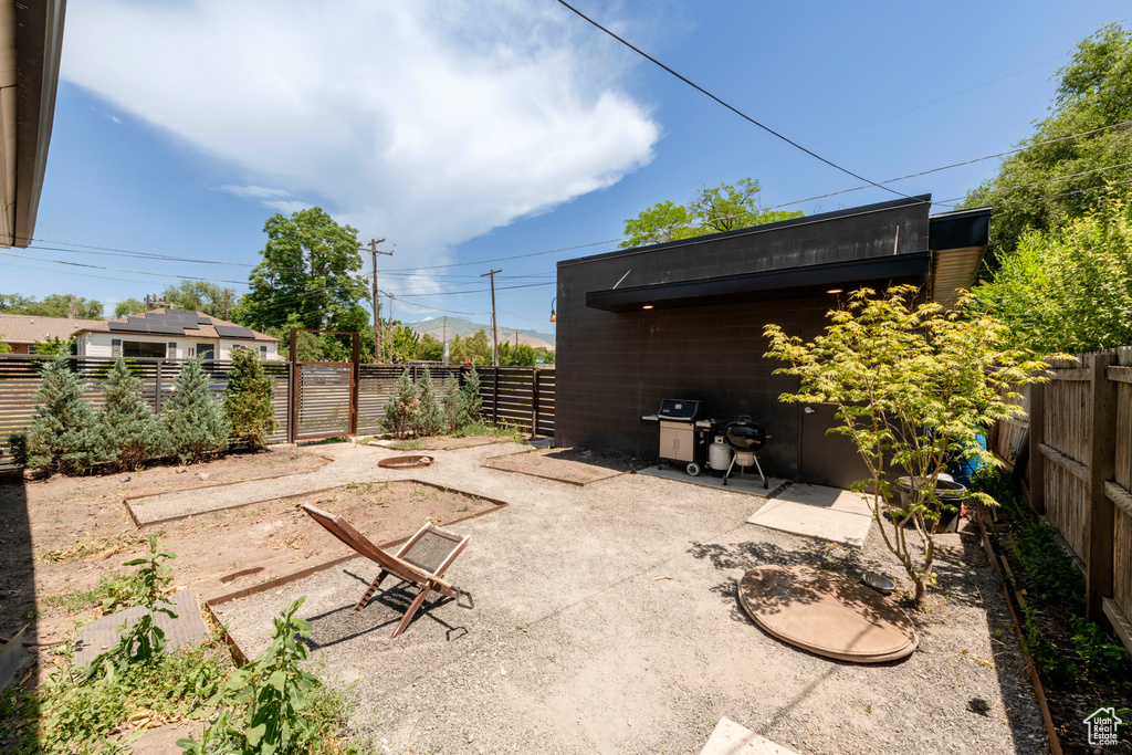 Fenced backyard featuring grilling area and a patio area