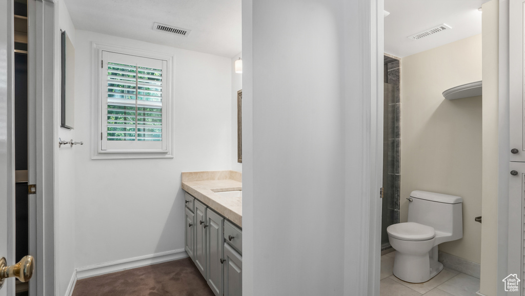 Full bath featuring vanity and toilet