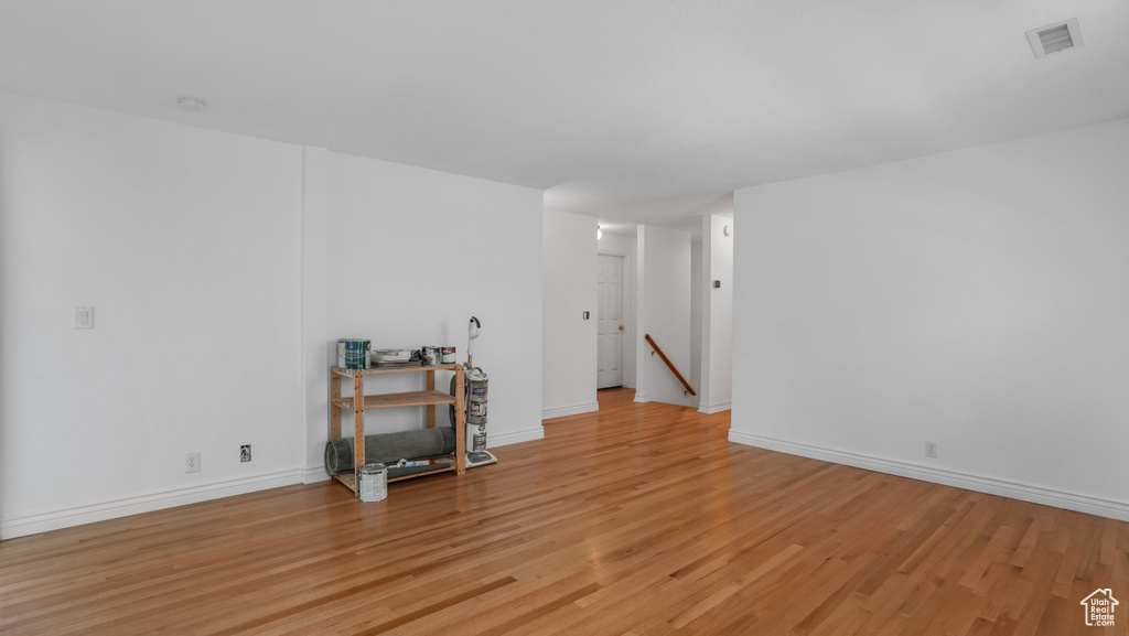 Spare room featuring light wood-type flooring and a smoke detector
