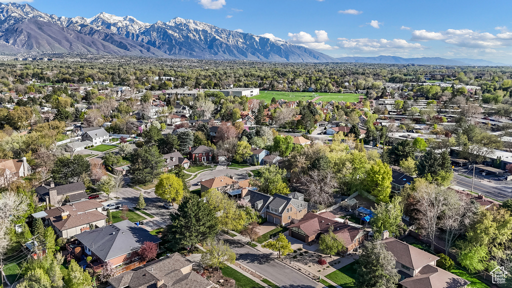Aerial view of property and surrounding area with nearby suburban area