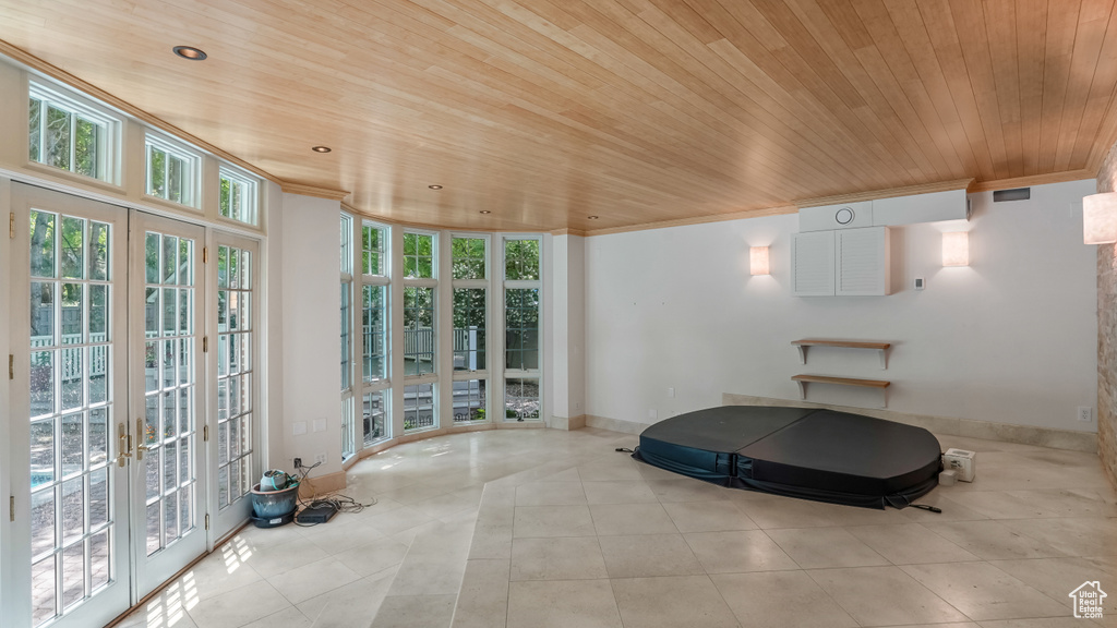 Workout area with wood ceiling, french doors, tile patterned flooring, recessed lighting, and ornamental molding