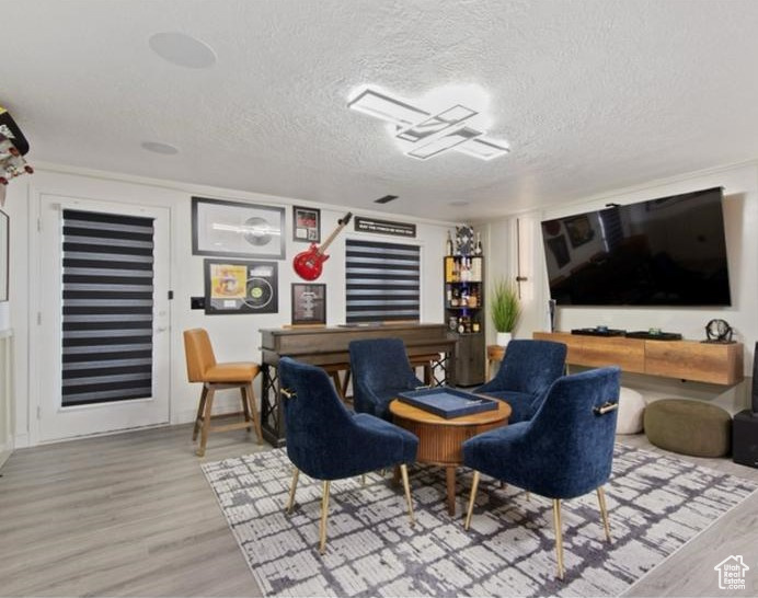 Interior space with a textured ceiling and wood finished floors