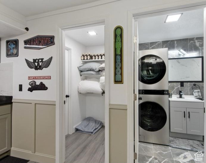 Laundry area with stacked washer / dryer and cabinet space