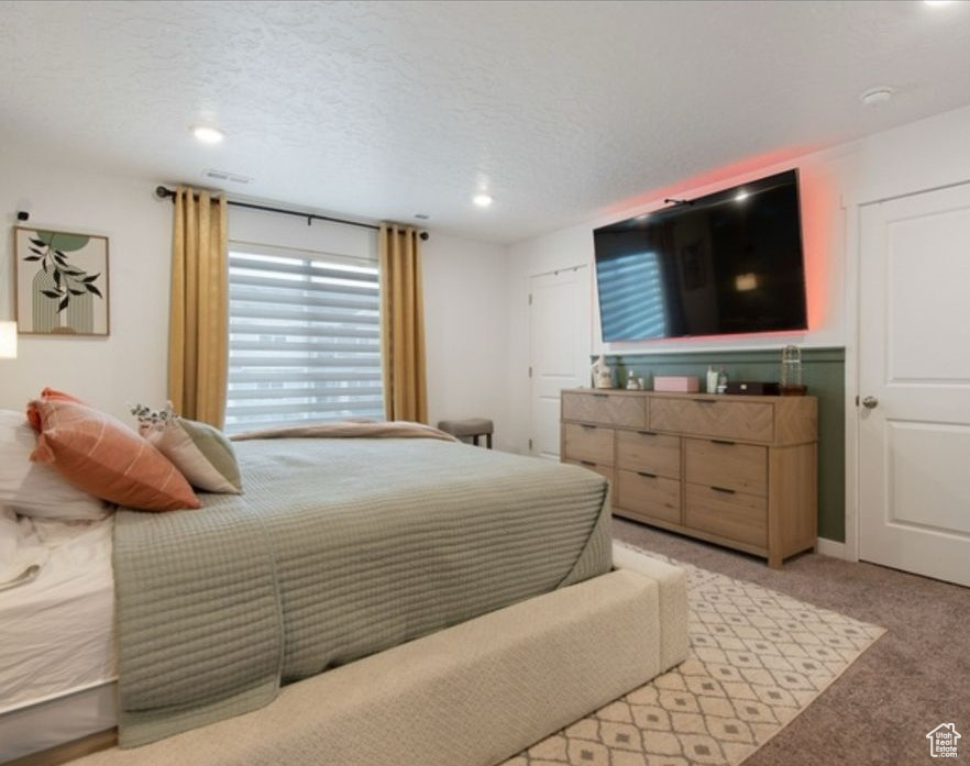 Carpeted bedroom featuring recessed lighting