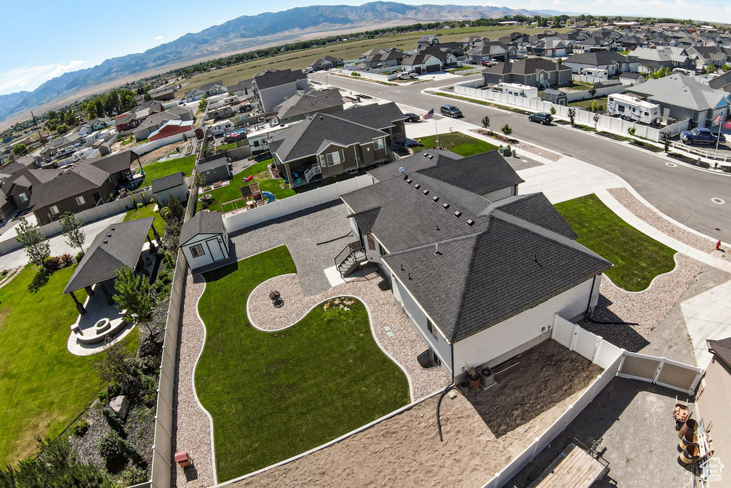 Aerial perspective of suburban area featuring a mountain backdrop