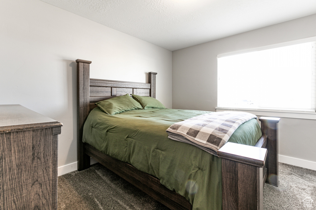 Carpeted bedroom featuring baseboards