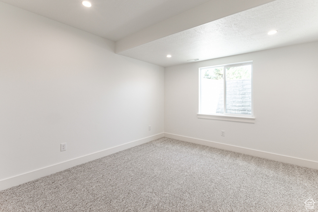 Unfurnished room featuring recessed lighting and light colored carpet