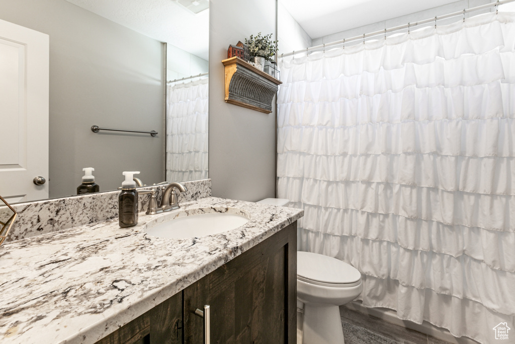 Full bath featuring vanity and curtained shower