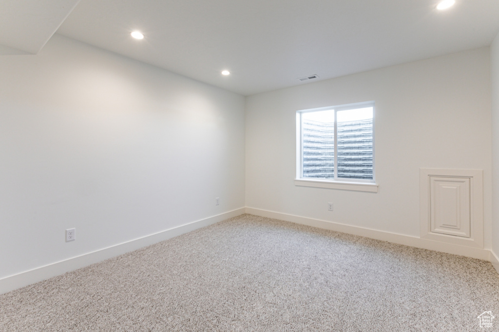 Spare room featuring recessed lighting and light colored carpet