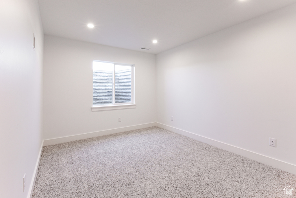 Unfurnished room featuring recessed lighting and carpet