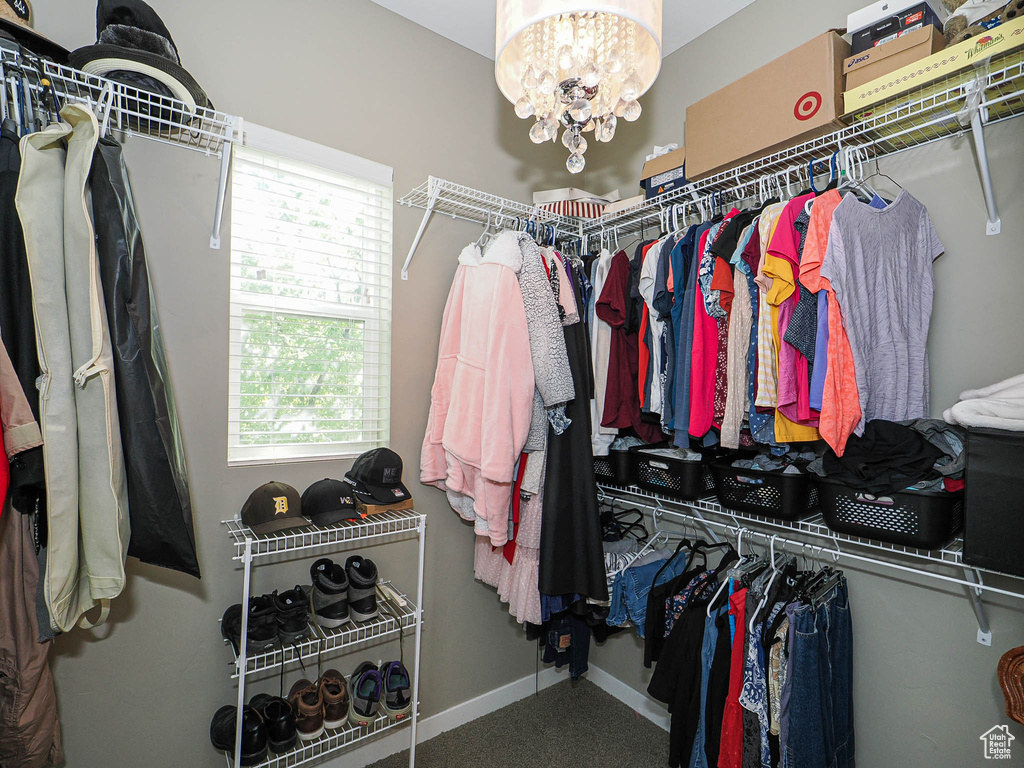 Walk in closet with a chandelier