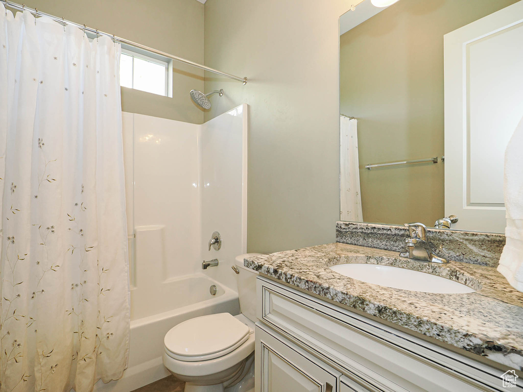 Full bathroom featuring vanity and shower / bathtub combination with curtain