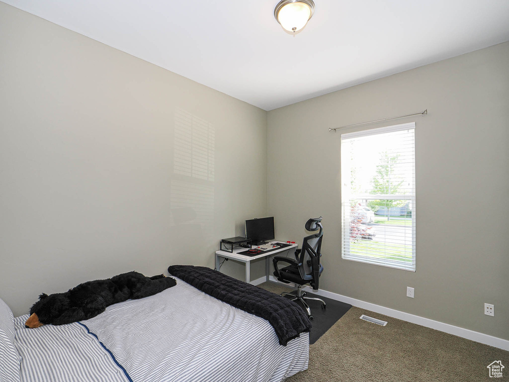 Bedroom with baseboards and carpet flooring