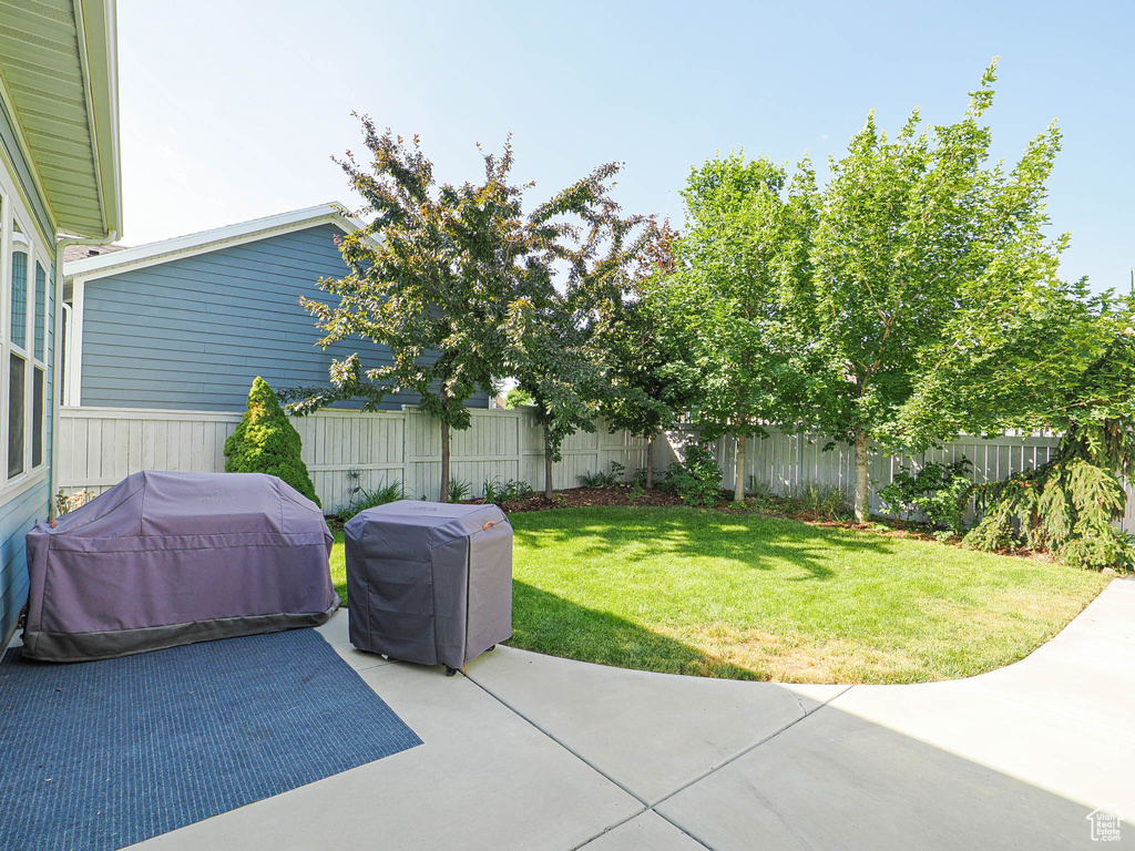 Fenced backyard featuring a patio