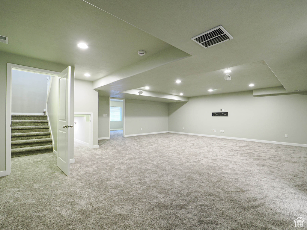 Below grade area featuring carpet, stairway, and recessed lighting