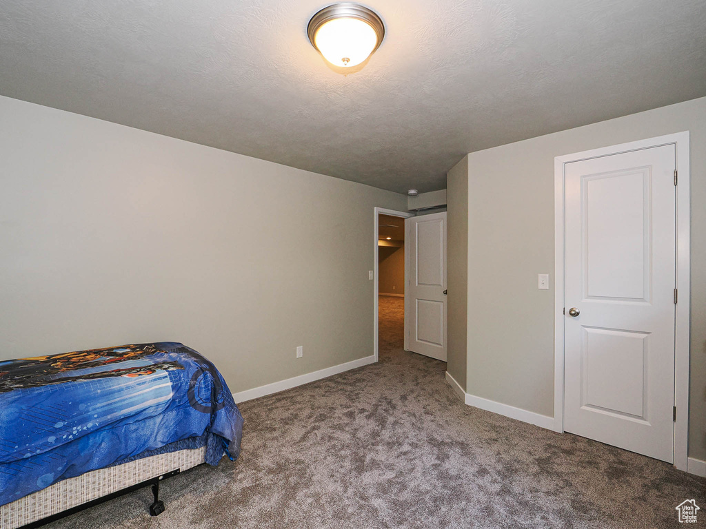 Carpeted bedroom featuring baseboards