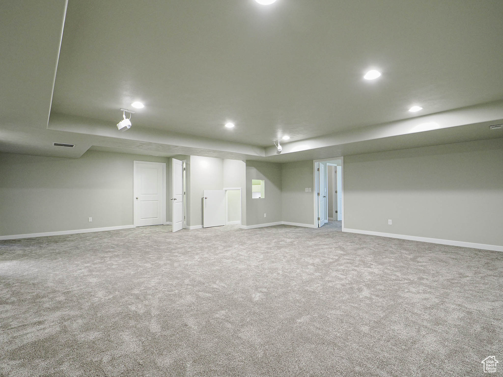 Finished basement with carpet flooring and recessed lighting