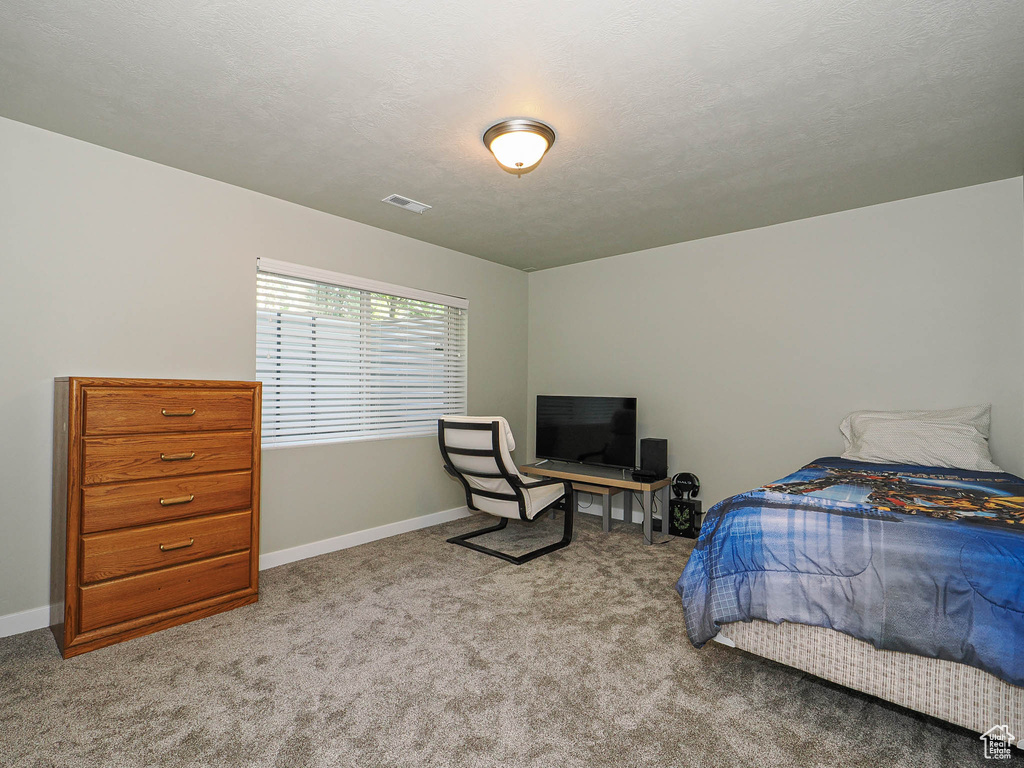 Carpeted bedroom with baseboards