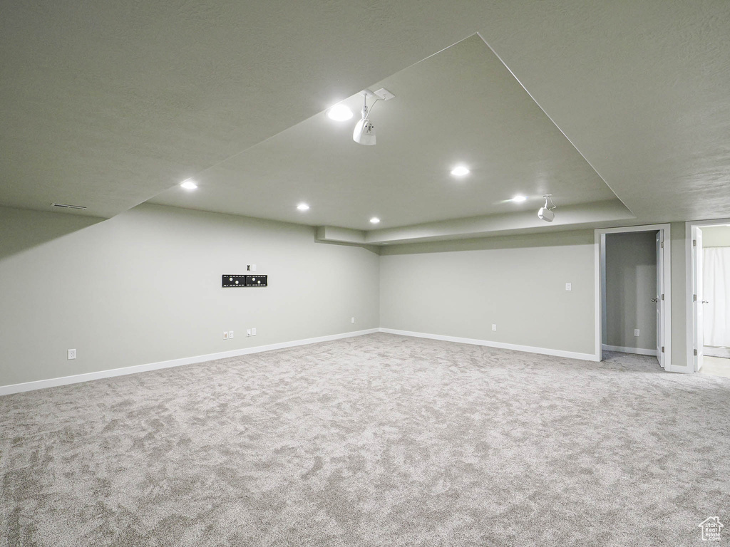 Finished below grade area with recessed lighting and carpet flooring