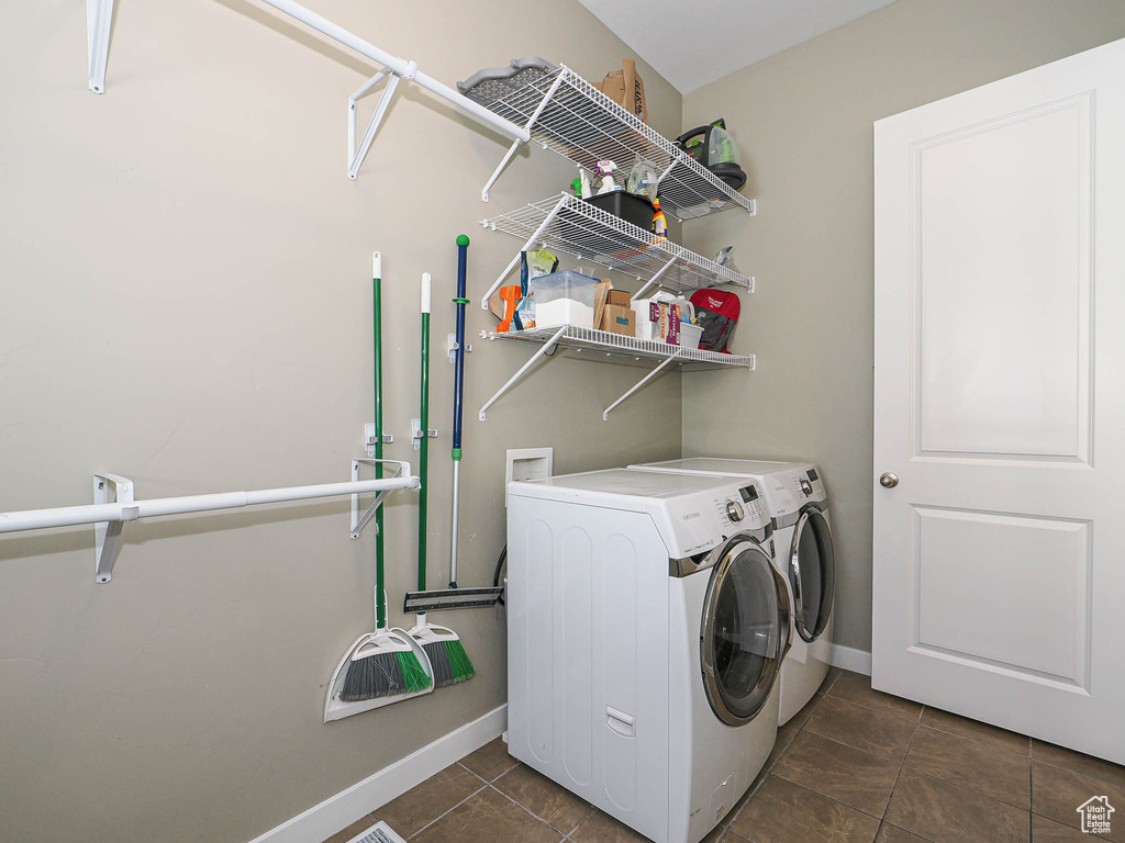 Laundry room with separate washer and dryer and dark tile patterned flooring