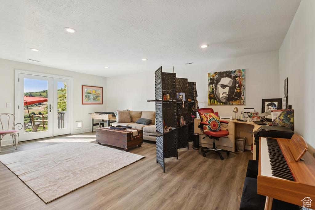 Living area featuring wood finished floors, recessed lighting, and a textured ceiling