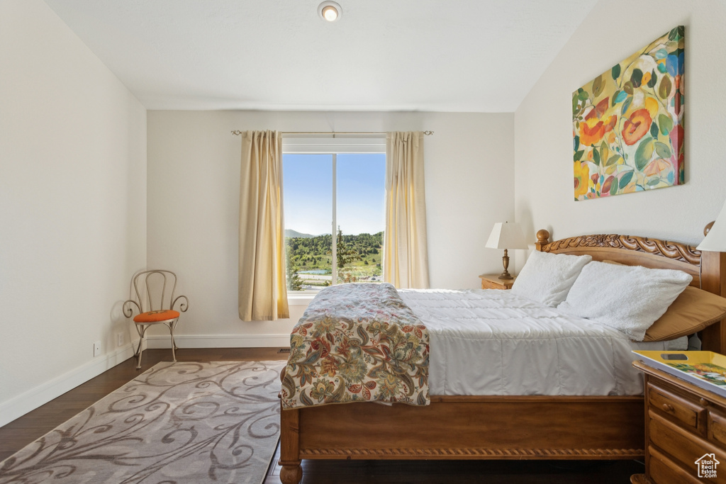 Bedroom featuring wood finished floors and a mountain view