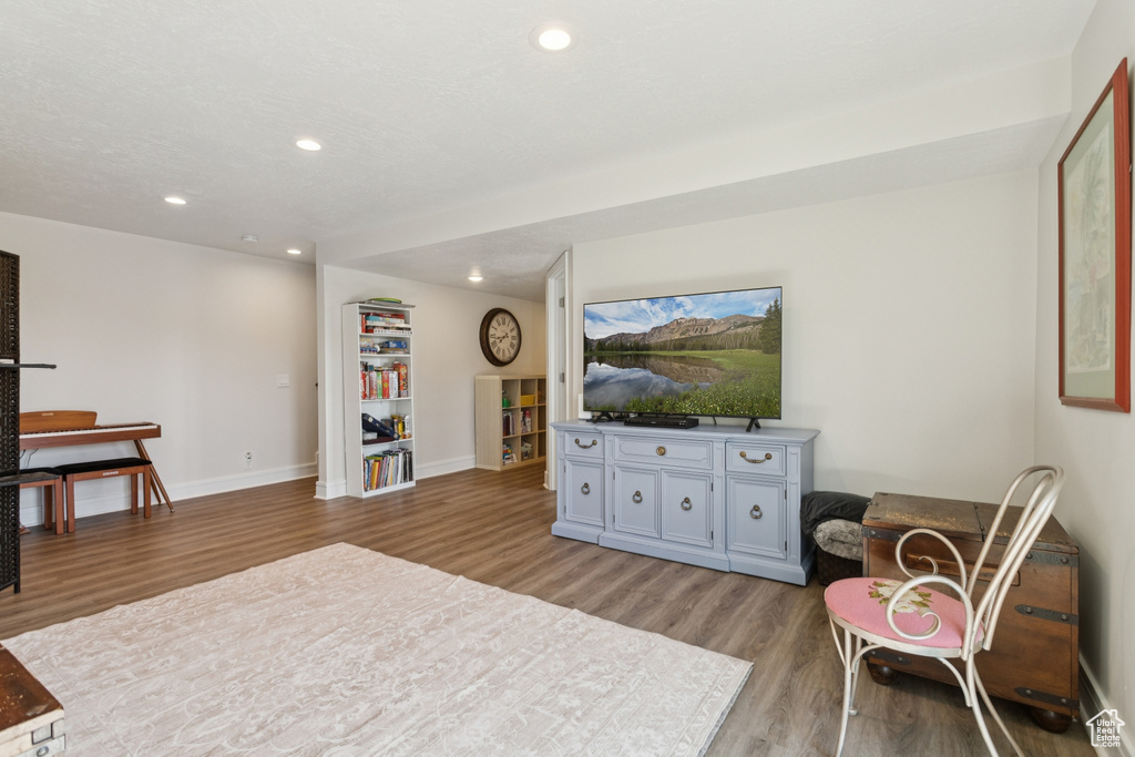 Living area featuring light wood-style floors and recessed lighting