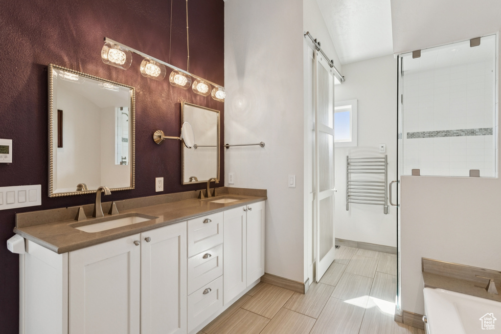 Full bath with double vanity, a bath, and a shower