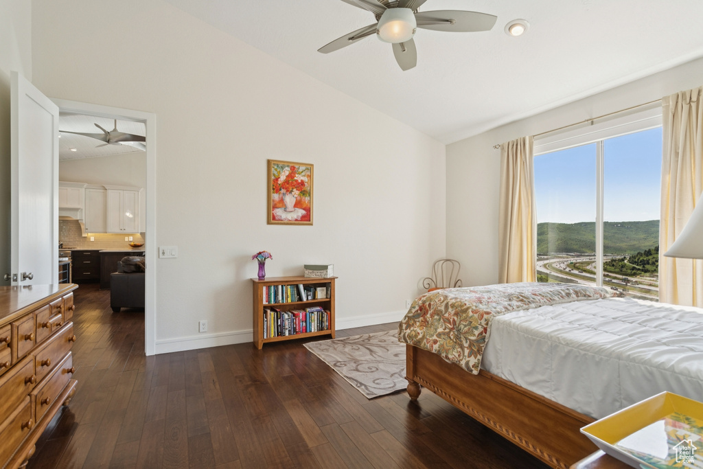 Bedroom featuring dark wood-type flooring, high vaulted ceiling, and ceiling fan