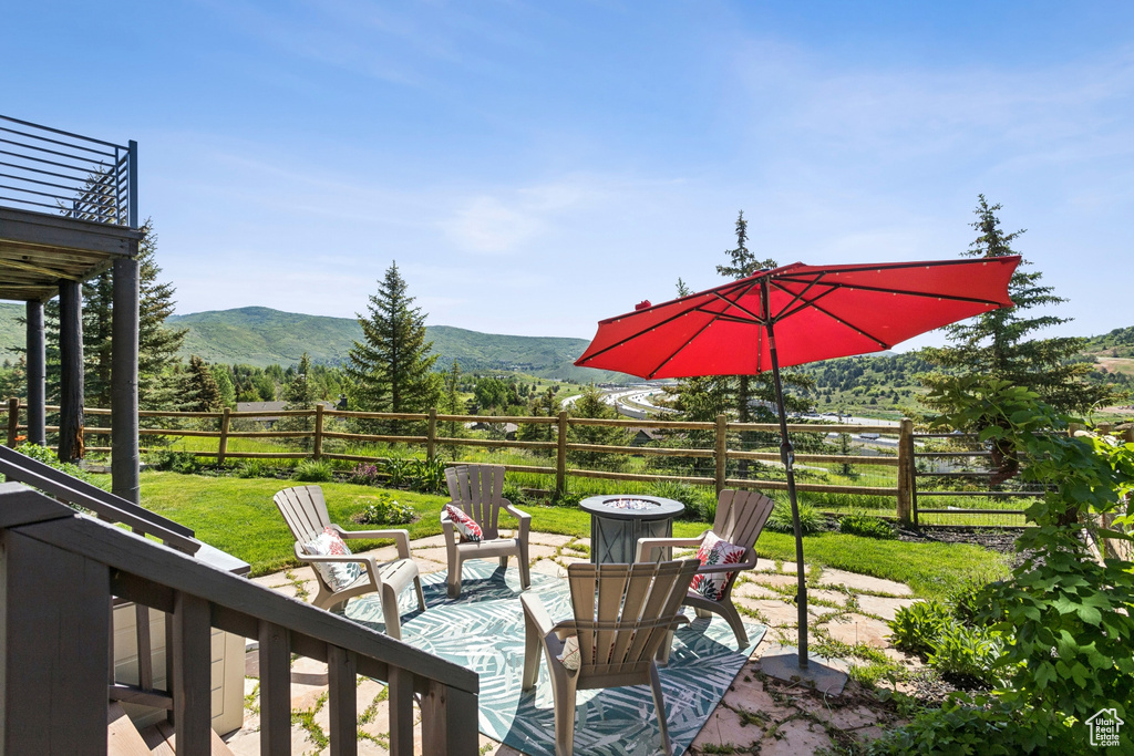 View of patio featuring an outdoor fire pit and a mountain view