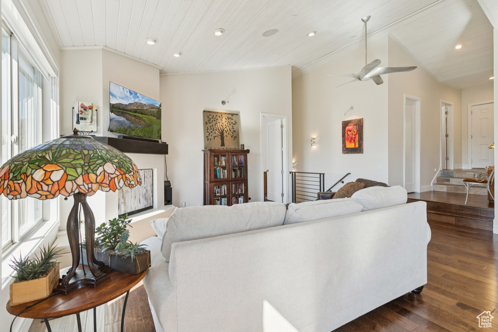 Living area featuring dark wood-style flooring, a ceiling fan, recessed lighting, vaulted ceiling, and wooden ceiling