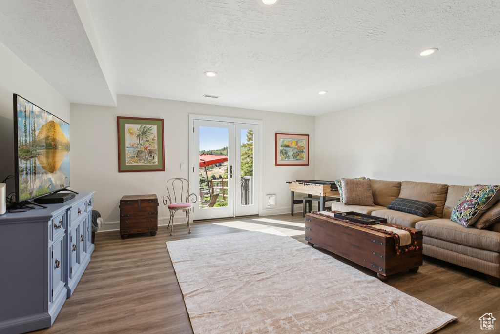 Living area with wood finished floors and recessed lighting