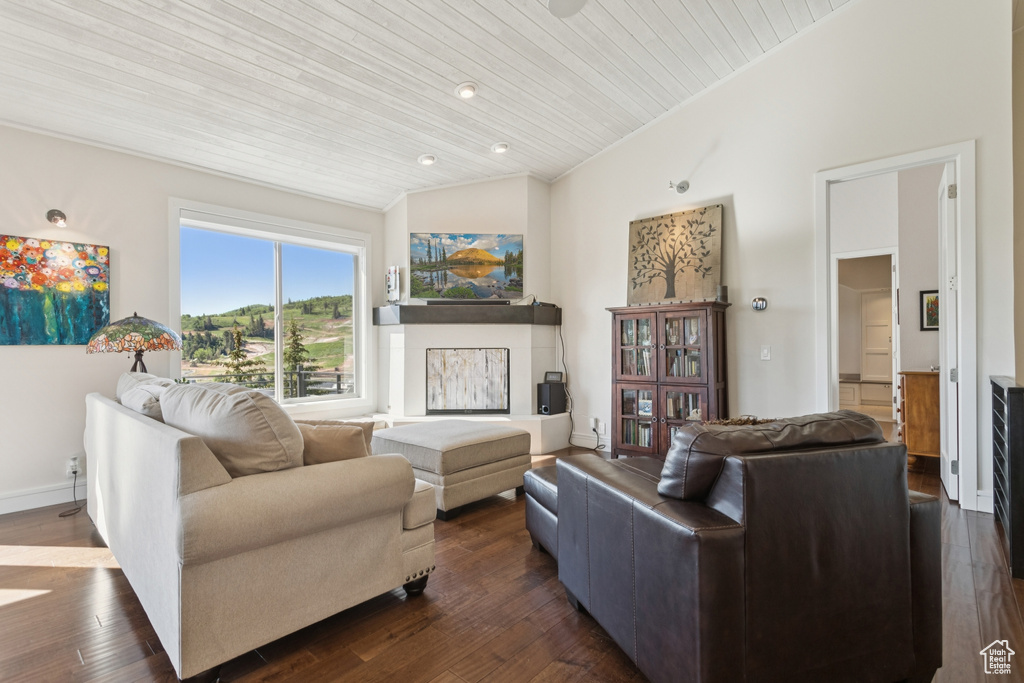 Living room with lofted ceiling, wooden ceiling, and dark wood finished floors