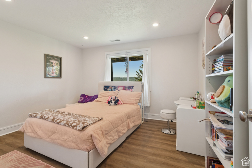 Bedroom featuring wood finished floors and recessed lighting