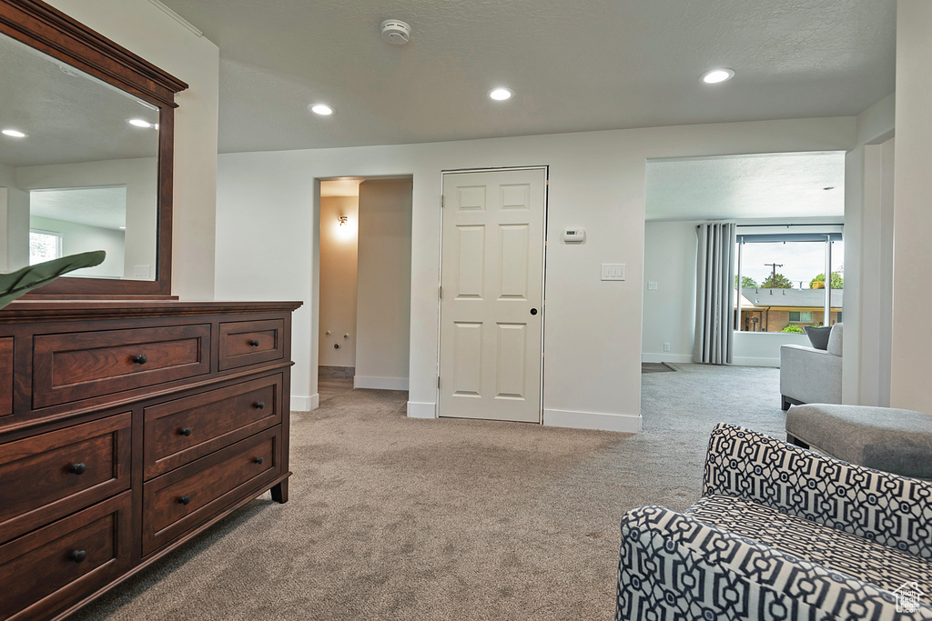 Bedroom with light carpet and recessed lighting