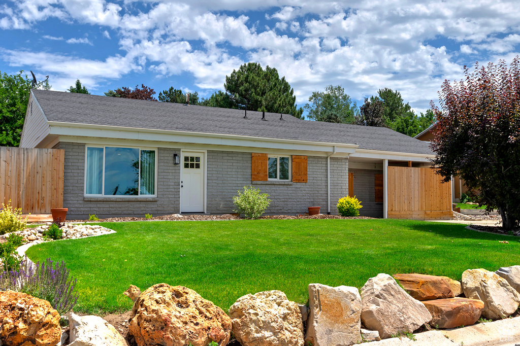 View of front of home with brick siding and a shingled roof