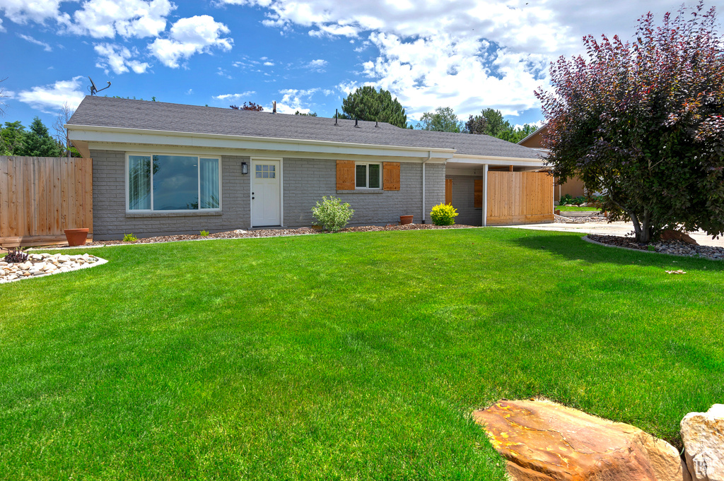 Ranch-style house featuring brick siding
