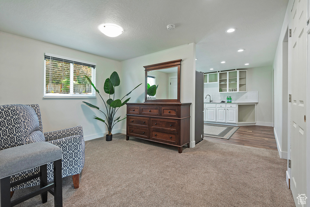 Living area featuring carpet floors, recessed lighting, and a textured ceiling