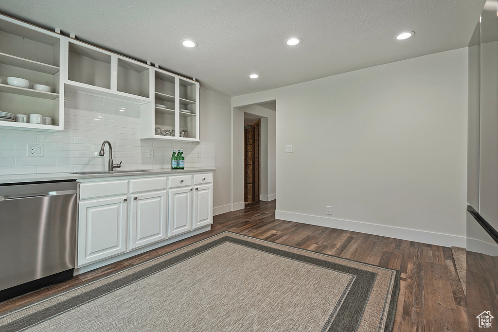 Kitchen featuring dishwasher, dark wood-style flooring, decorative backsplash, light countertops, and recessed lighting