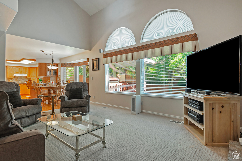 Living room featuring light carpet and vaulted ceiling