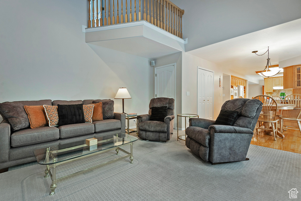 Living room featuring a high ceiling and wood finished floors