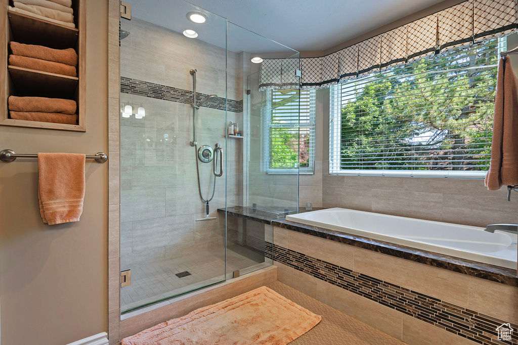 Bathroom featuring a garden tub, a shower stall, recessed lighting, and tile patterned floors