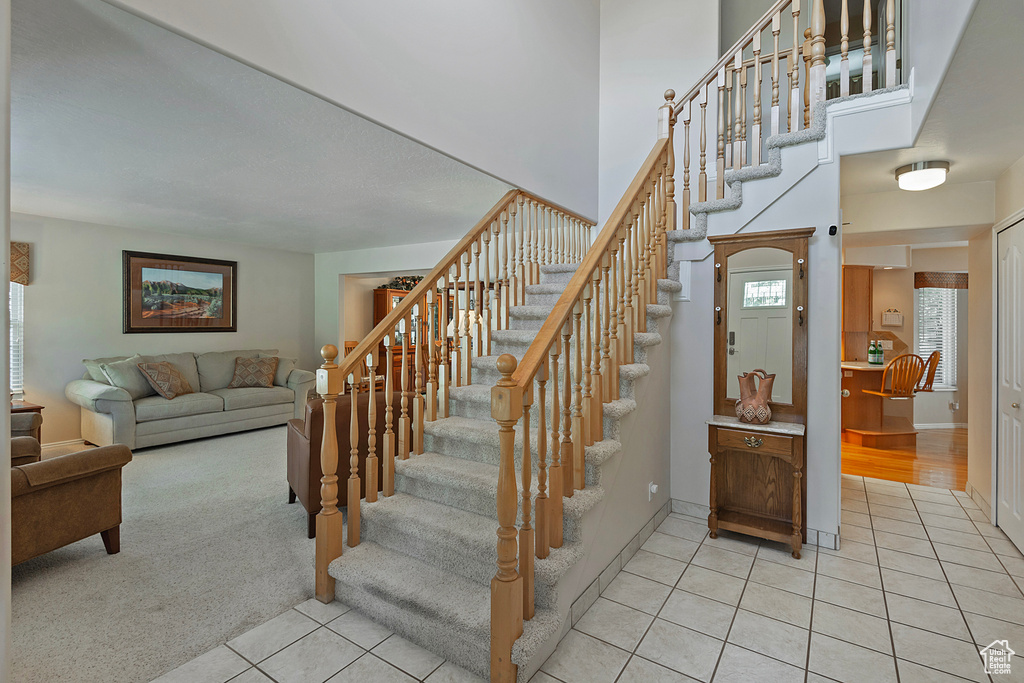Staircase featuring tile patterned flooring and baseboards