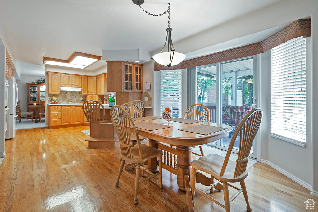 Dining space featuring light wood-style floors and baseboards