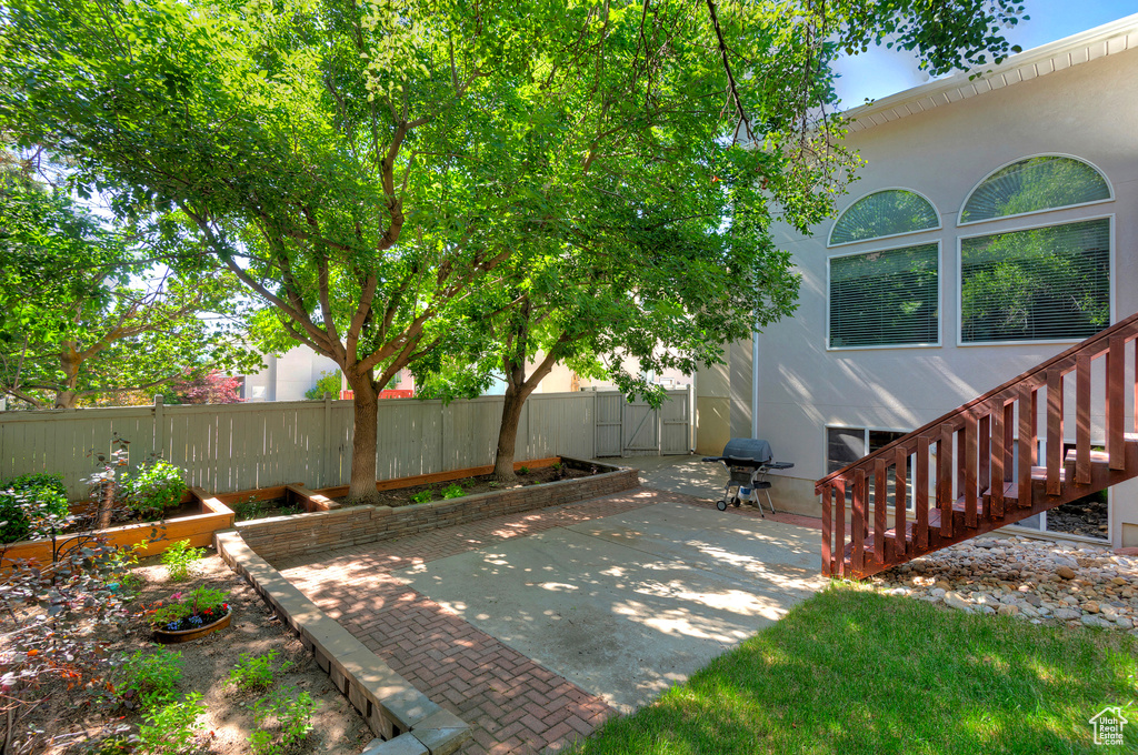 Fenced backyard featuring a patio