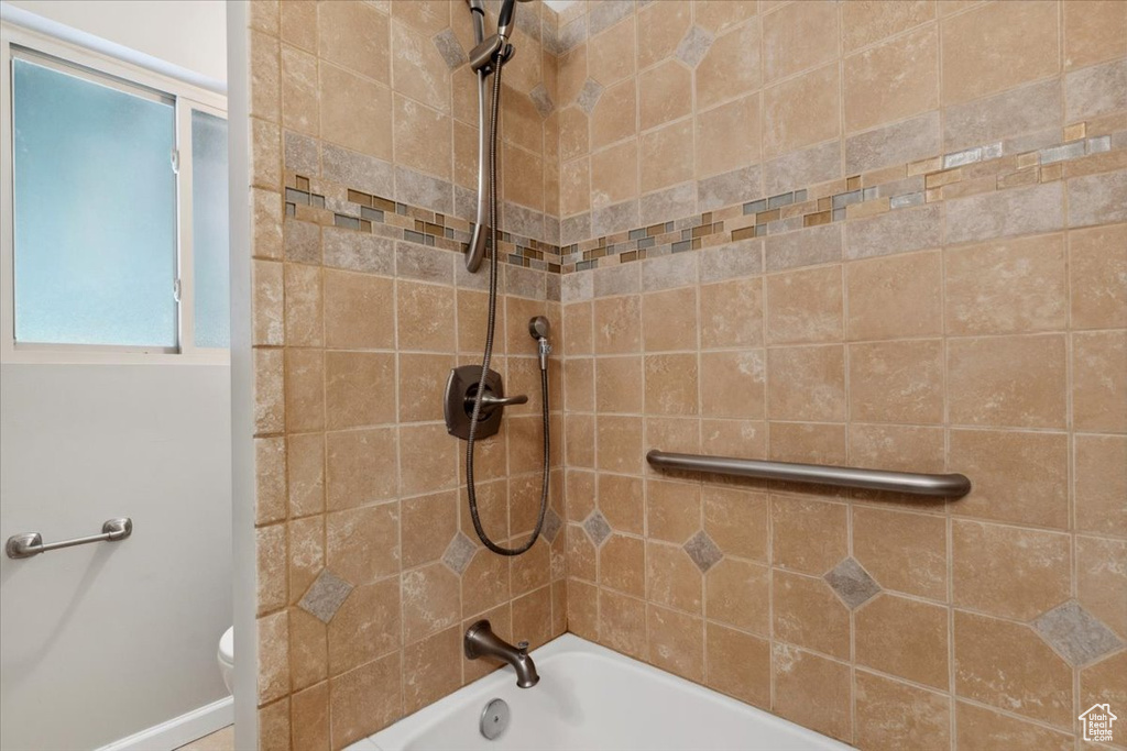 Full bathroom with shower / washtub combination and toilet