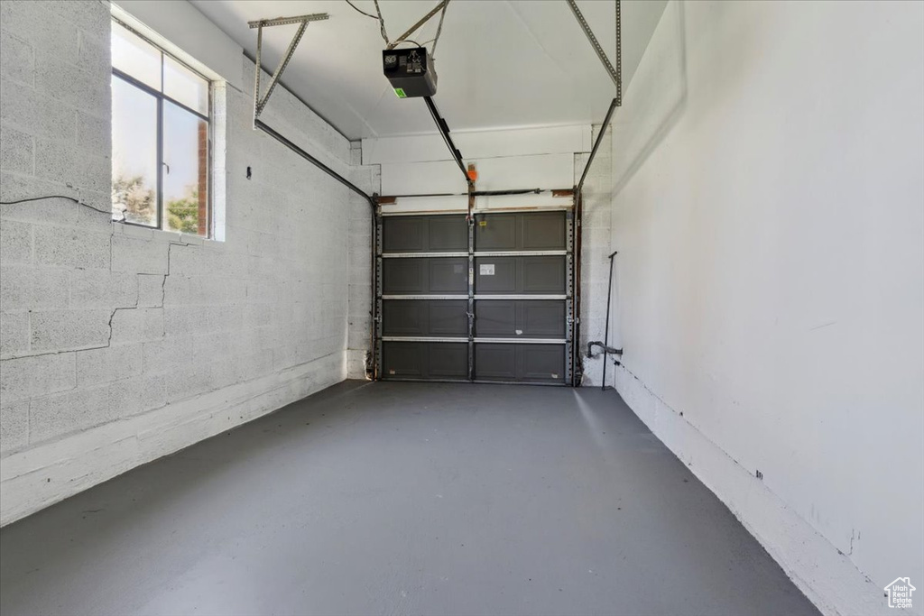 Garage with a garage door opener and concrete block wall