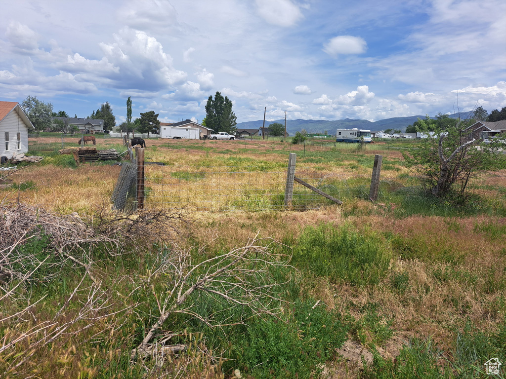 View of yard featuring a rural view and a mountain view